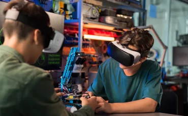 two-young-men-vr-glasses-doing-experiments-robotics-laboratory-robot-table